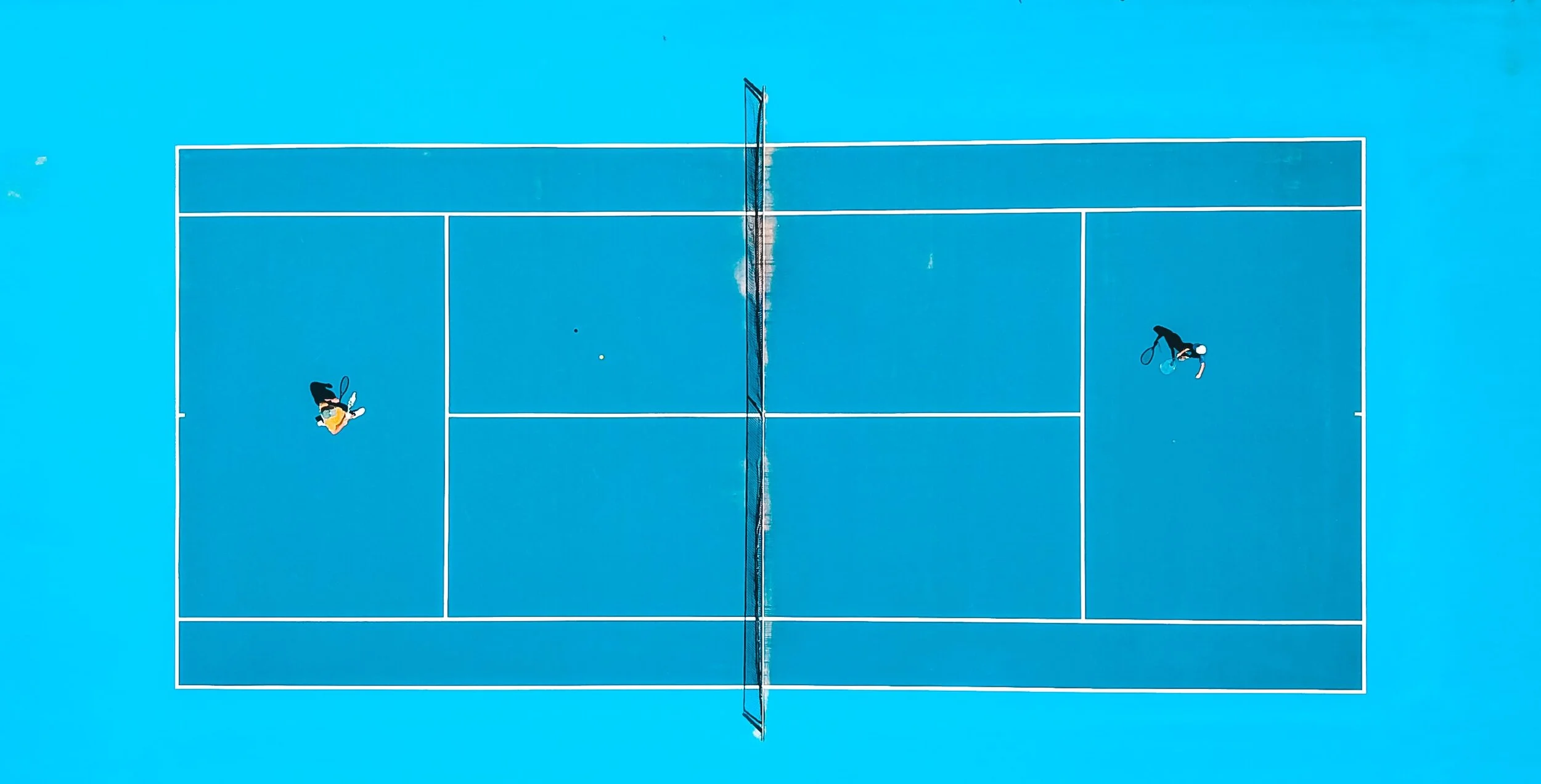 Aerial view of blue tennis court